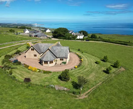 Superb sea views and wraparound garden on offer at this spacious bungalow : Fieldview Aerial 1